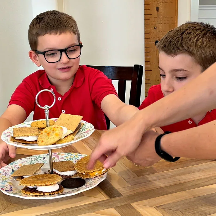 Image shows kids eating Smores for a post about different ways to make Smores when you don't have graham crackers.