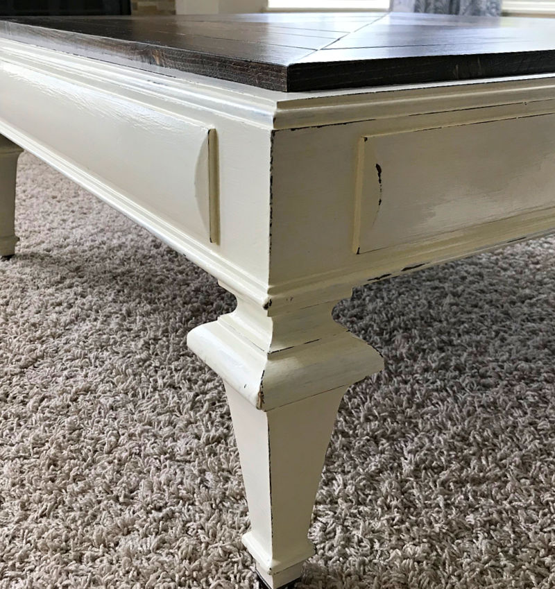 Image of a white painted coffee table with distressed edges.