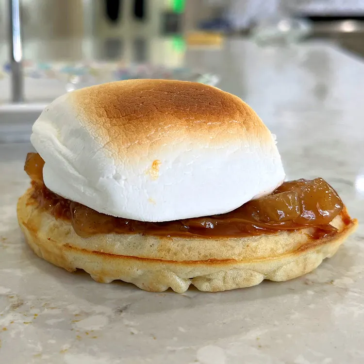 Toasted waffle with Dulce De Leche, Apple Pie Filling, and roasted marshmallow for a post about ways to make Smores at home.