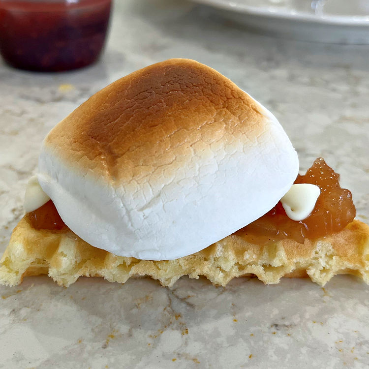 Image of Apple Pie filling and white chocolate chips on a toasted waffle Smores.