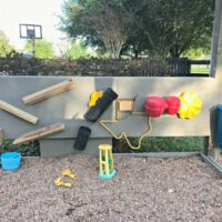 How I built a kids gravel play area, rustic bench, and outdoor activity wall. Keeps kids busy for hours without the mess of sand.