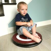 You can make your own easy DIY kids sit & spin toy. And it's pretty easy with pre-cut wood rounds and galvanized pipes and flanges. I've even included the free Captain America Printable as a download.