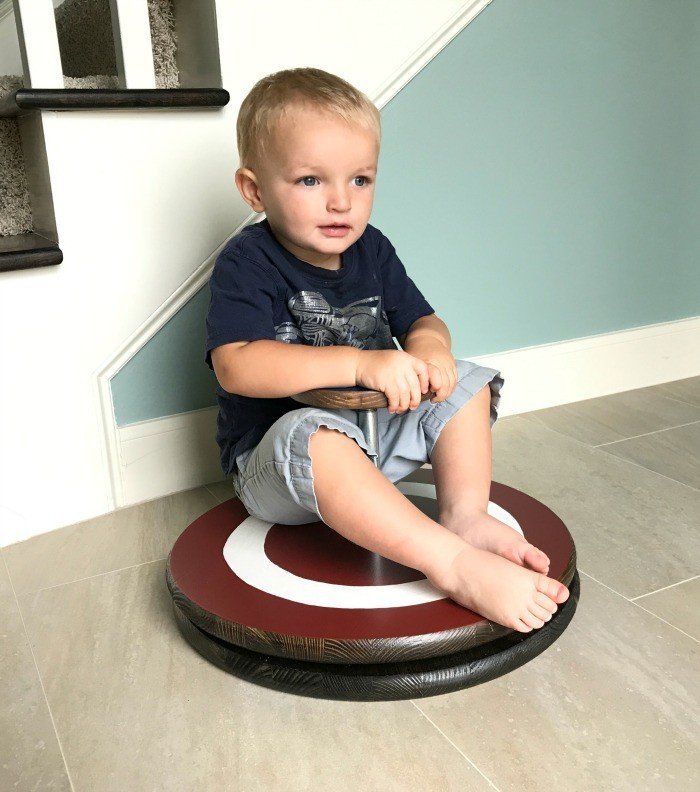 You can make your own easy DIY kids sit & spin toy. And it's pretty easy with pre-cut wood rounds and galvanized pipes and flanges. I've even included the free Captain America Printable as a download.