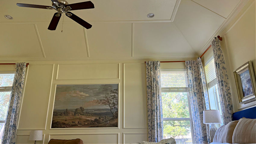 Crown Molding on vaulted ceiling with trim and plywood panels painted white. DIY vaulted tray ceiling idea.