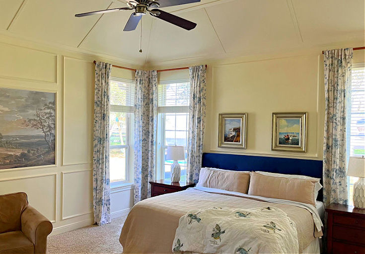An example of 
 DIY vaulted tray ceiling molding ideas in a bedroom painted white.