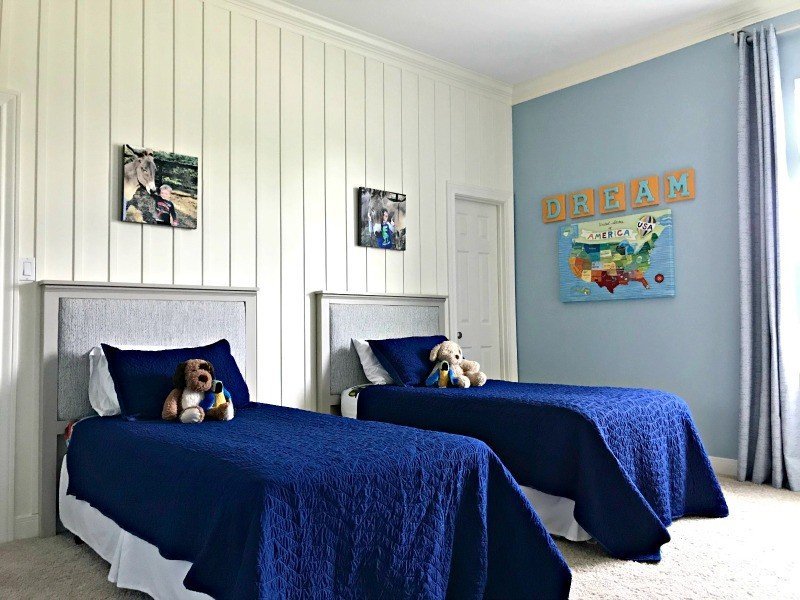 It's time for the boys bedroom makeover reveal, guys! And I'm so excited to share it with you. The whole room is full of awesome DIY projects, affordable decor, and fun boys bedroom ideas. I'm loving it and so are my boy's! This is a blue, white, and grey bedroom full of pops of fun colors. I think it's a bit Farmhouse, a bit traditional, and a bit Land of Nod. I designed this for my boys, but most of the ideas would work for all kids, boys and girls. #kidsbedroom #kidsroom #boysbedroom #bedroomideas