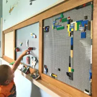 Image of a small kid playing at a DIY Wood Kids Activity Board.