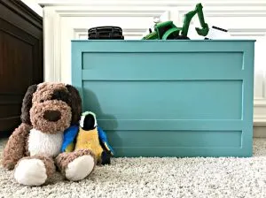 A fun teal large kids DIY wooden storage box. Kids playroom toy storage in a open DIY teal crate and a low dresser. Build a Modern Farmhouse DIY Wooden Toy Storage Crate or Box for all of those kids toys cluttering up your house. Makes a beautiful throw pillow and blanket box in a Living Room or catch all storage box for teens too! #AbbottsAtHome #StorageBox #ToyBox #DIYStorage