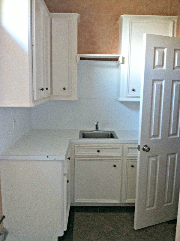 Before photo on my white and grey Boho & Farmhouse Style Laundry Room Makeover. This post is full of Before & After Makeover Photos, budget-friendly DIY ideas, and Laundry Room decor. #LaundryRoom #BeforeandAfter #AbbottsAtHome
