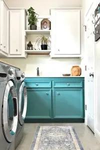 This Colorful Laundry Room Makeover is full of easy DIY updates you can easily do in your own home. This colorful laundry room makeover looks great with boho, farmhouse, and traditional homes. Combine light upper cabinets and colorful green lowers for a fresh, open, light, and bright space.