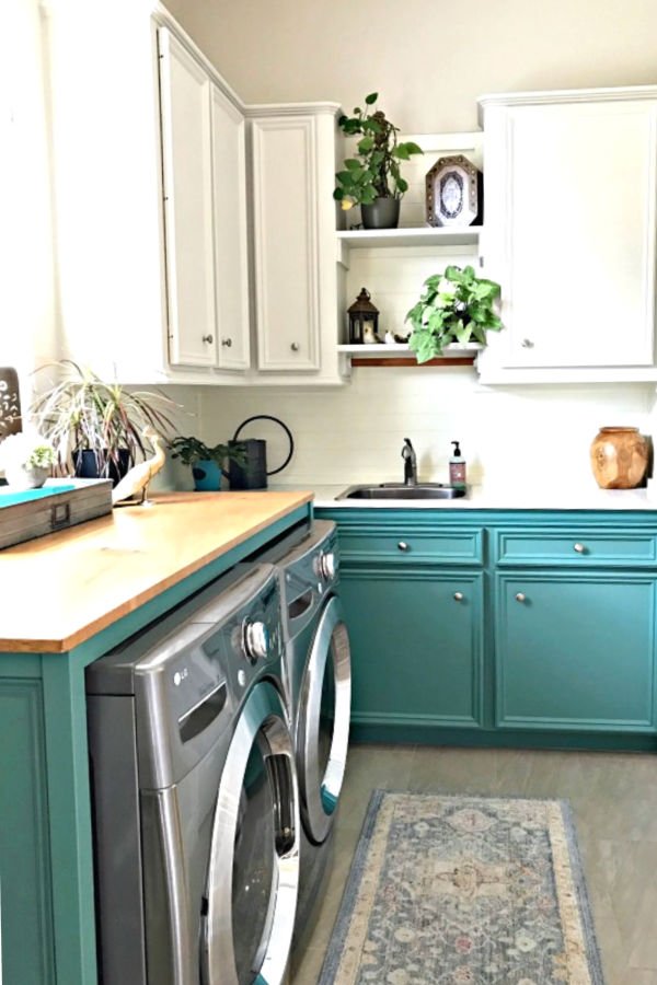 This Colorful Laundry Room Makeover is full of easy DIY updates you can easily do in your own home. This colorful laundry room makeover looks great with boho, farmhouse, and traditional homes. Combine light upper cabinets and colorful green lowers for a fresh, open, light, and bright space.