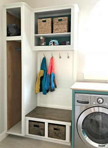 DIY Coat and shoe storage. A fresh Modern Farmhouse look using teal, wood, and lots of white. This Modern Farmhouse Small Laundry Room Design is full of easy DIY projects and affordable decor. #LaundryRoom #ModernFarmhouse #Teal #AbbottsAtHome