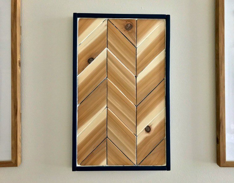 Here's a cool tutorial for DIY Chevron Wood Wall Art that I love! She used Cedar with accents of blue and white paint to add a chippy, distressed look. #AbbottsAtHome #WoodArt #WoodworkingIdea #DIYIdeas #Cedar #WallArt