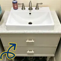Image of a bathroom vanity with drawers cut for plumbing.