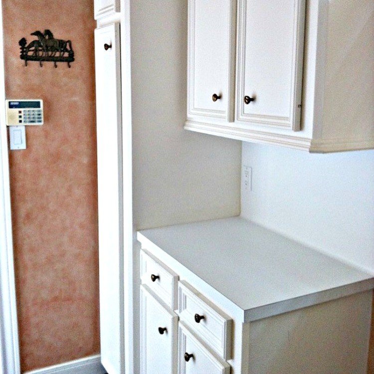 Love this DIY! Here are the cheap and doable DIY projects I used when I Added a Mudroom to our Laundry Room. #LaundryRoom #Mudroom #HomeRemodel #MudroomBench #AbbottsAtHome