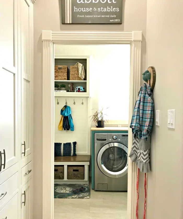 Love this DIY! Here are the cheap and doable DIY projects I used when I Added a Mudroom to our Laundry Room. #LaundryRoom #Mudroom #HomeRemodel #MudroomBench #AbbottsAtHome