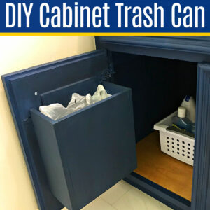 Image of a cabinet door mounted trash can inside a bathroom vanity. Text says "DIY Cabinet Door Trash Can".