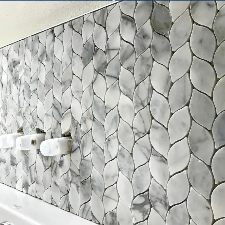 Leaf Pattern Marble Mosaic Tile installed on a bathtub backsplash.
