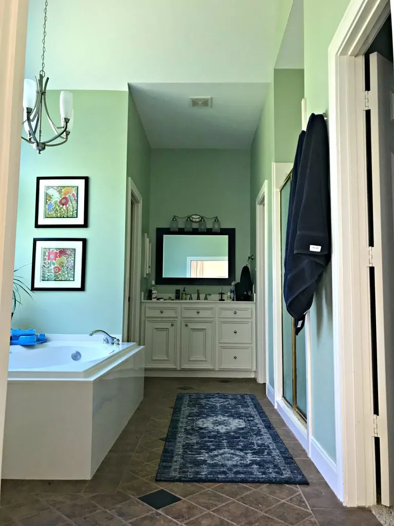 Here's a look at our Master Bathroom before the big makeover. It has 2 vanities, a big roman tub in front of a bay window and a walk in shower.
