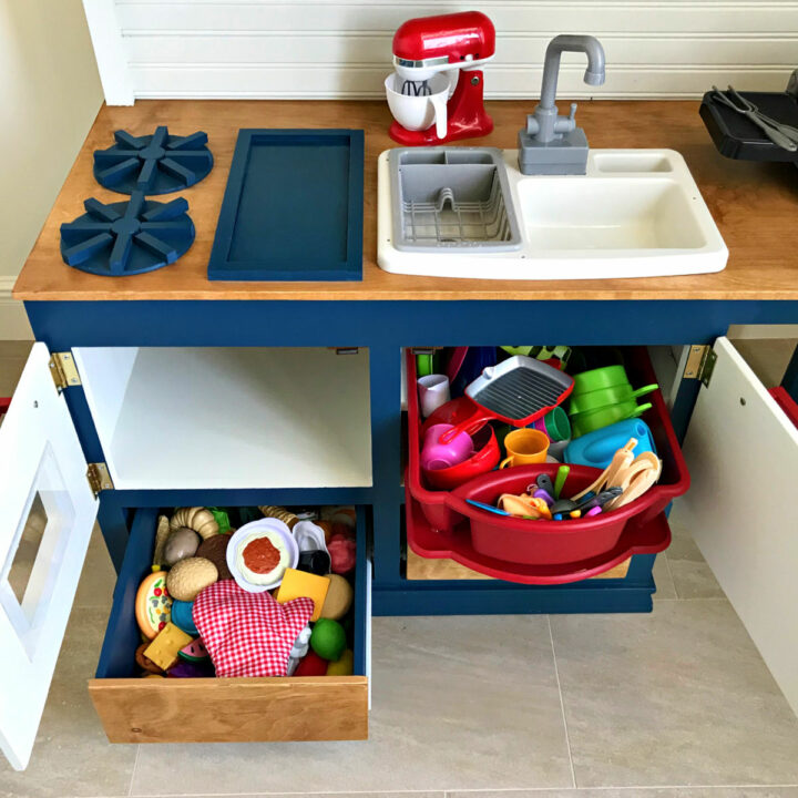 DIY Kids Play Kitchen with drawers for food storage, a play sink, stove top, pretend dishwasher, and more.