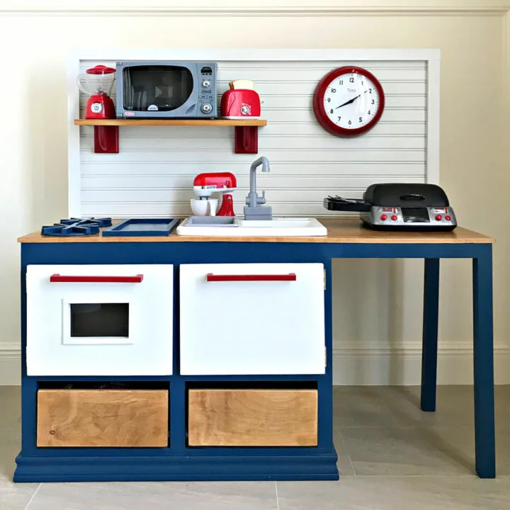 Front view of this DIY Play Kitchen painted red, white, and blue.