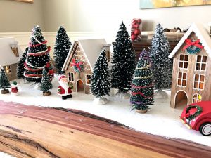 How to make this fun DIY Christmas Table Centerpiece with mini Christmas houses, bottle brush trees, and vintage red truck, camper, and car. DIY Red Truck Christmas Table Centerpiece. #AbbottsAtHome #CraftIdeas #CraftProjects #ChristmasProjects #ChristmasDIY