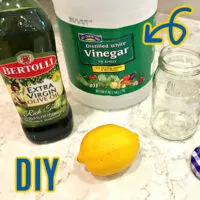 Image showing lemon, vinegar, and olive oil for a post about how to make DIY wood cleaner and 5 other homemade wood finishes and stain.