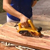 Image of someone using a Dewalt electric hand planer. In a post with tips and tricks for beginners.
