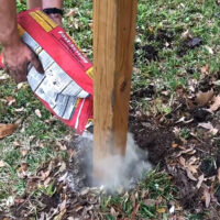 How to set wooden fence posts in concrete - written steps & a quick video to help you DIY your own Three Rail or any other wooden fence style.