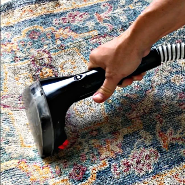 Here's How to Clean Area Rugs At Home, using a Bissell SpotClean Pro. Steps and tips for small stains and for rugs with all over dirt and stains.