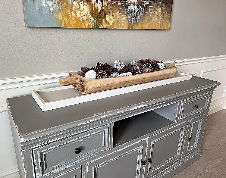 A Dining Room Buffet with a distressed grey over white chalk paint makeover.