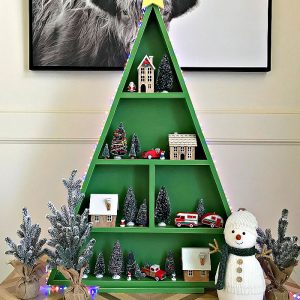 Easy woodworking steps & video for this big table top or floor-sized DIY Wood Christmas Tree Shelf. Printable woodworking plans, easy enough for beginner woodworkers. I'm loving this fun way to display all of my favorite Christmas decorations. This DIY Wood Christmas Tree Shelf is a great display for Cookies & Cocoa Bars, Christmas Villages, Advent Calendars, Christmas Ornaments and more.