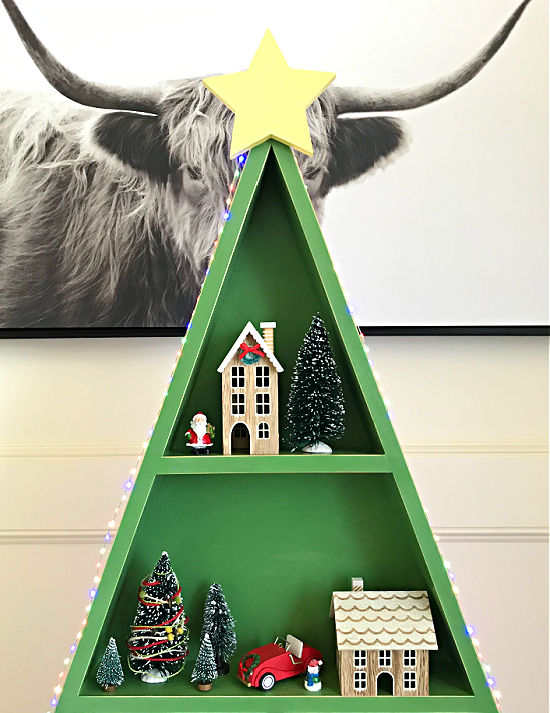 I'm loving this easy woodworking project! This DIY Wood Christmas Tree Shelf is a great display for Cocoa Bars, Christmas Villages, or Ornaments. Printable woodworking plans, easy enough for beginner woodworkers. 