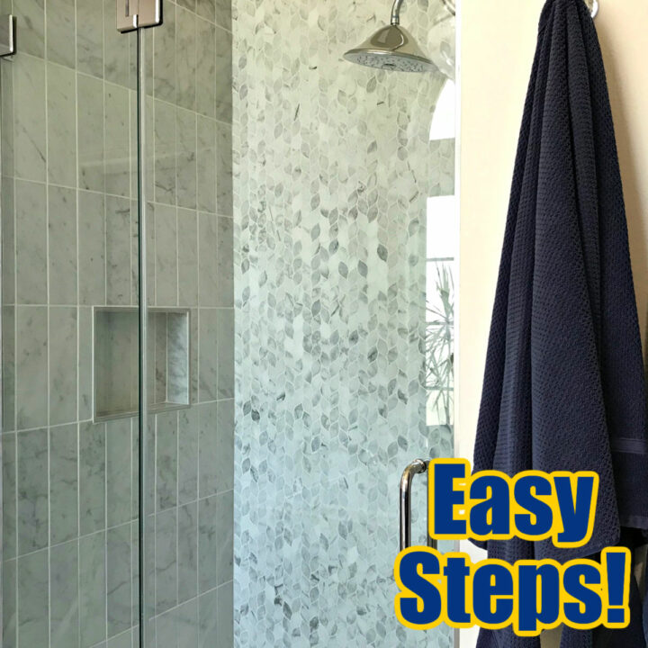 Image of a glass shower door cleaned with vinegar and baking soda. Wit DIY how to steps. Shower has marble tile.