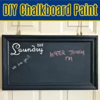 Image of wood painted with dark blue homemade chalkboard paint using grout and latex paint. Text says 