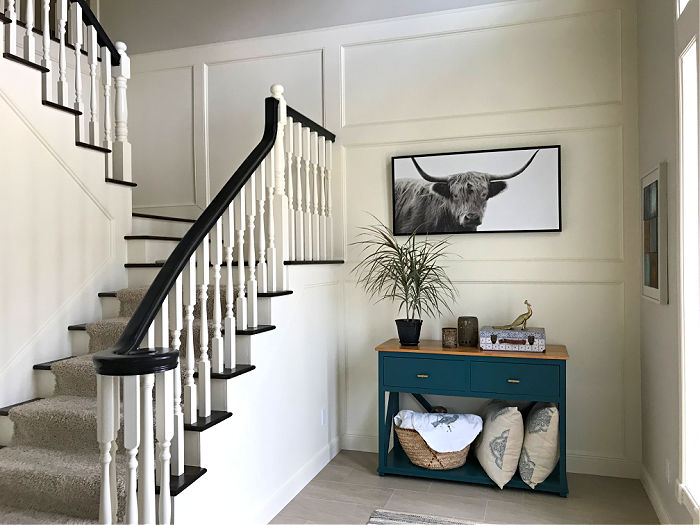 White 2 Story Foyer with trim and molding around a staircase.