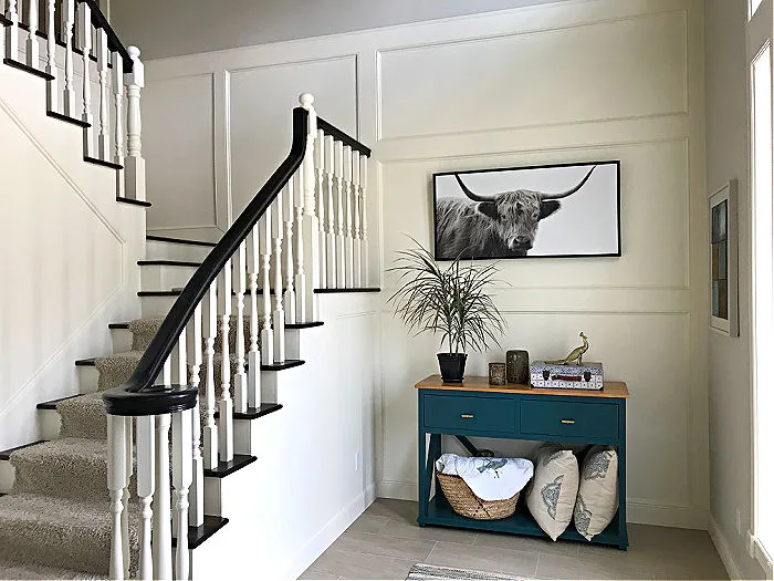 White 2 Story Foyer with trim and molding around a staircase.