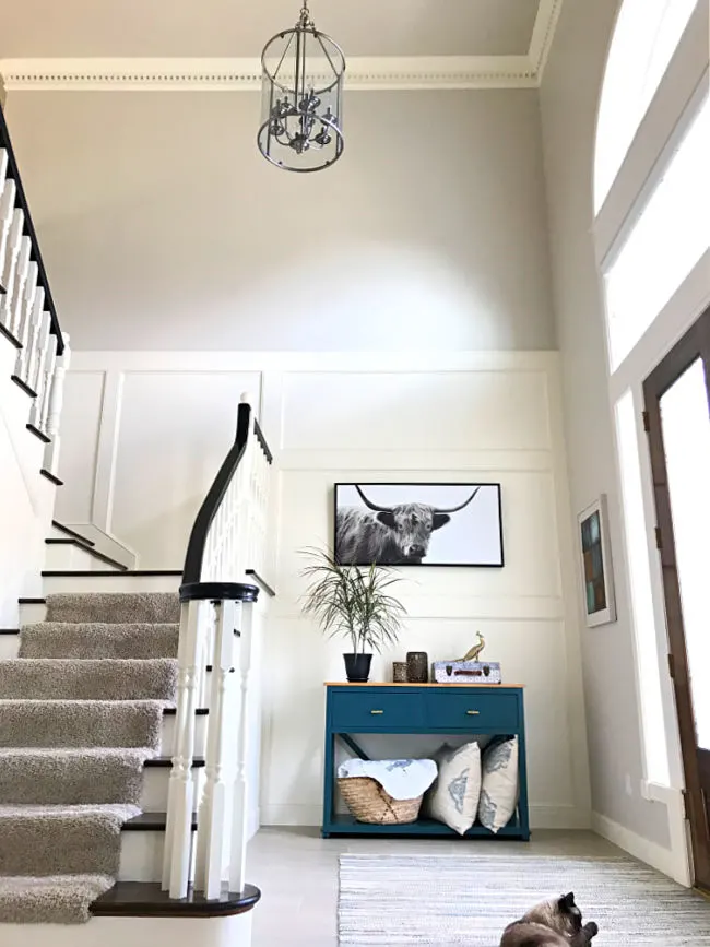 Large 2 story entryway in a home with white trim and molding everywhere.