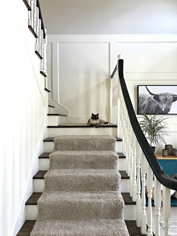 White foyer with stairs, looking up the stairs.