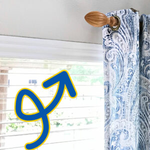 Arrow pointing at the valence on vinyl blinds. For a post about how to replace or fix broken valence clips.