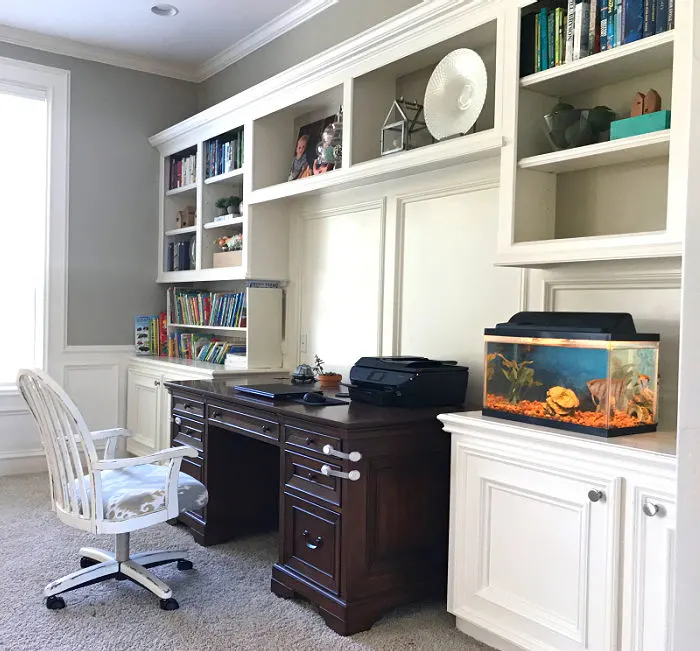 Image of a Home Office with white built-ins and a wood stain desk.