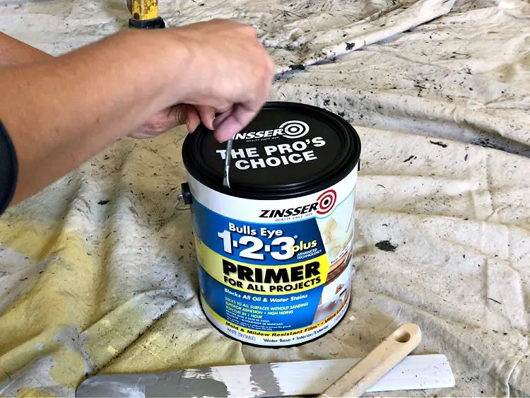 Image of Zinsser 123 Plus Primer being opened to paint over water stains.