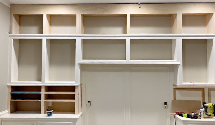 Floor to ceiling, wall to wall DIY office cabinets built-in with trim molding.