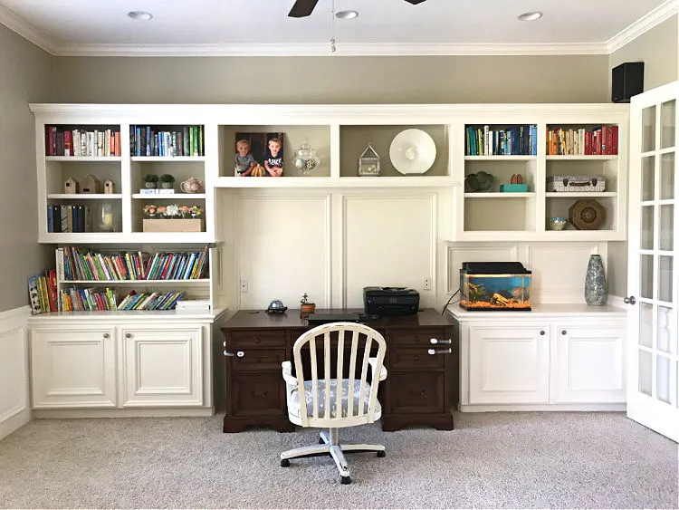 Before photo from a home office remodel. This home office has white built in cabinets for storage.
