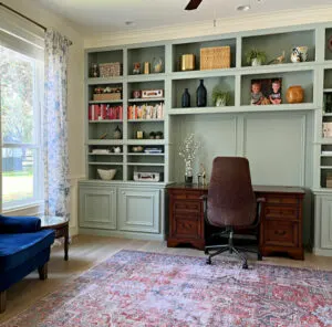 DIY home office makeover with a large area rug and library style shelves and built-ins.