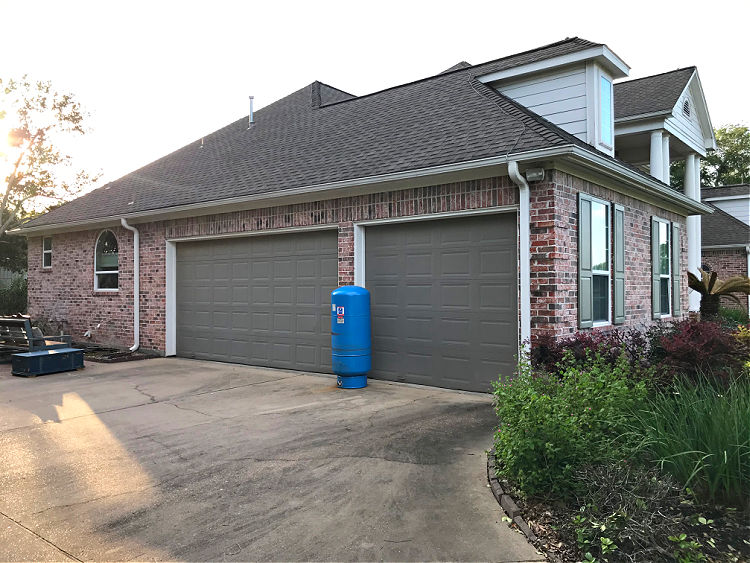 Garage side of a brick house.