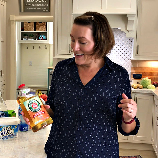 Image someone holding a floor cleaner that can actually cause dirt and grease to be trapped in the grout, making it harder to clean.