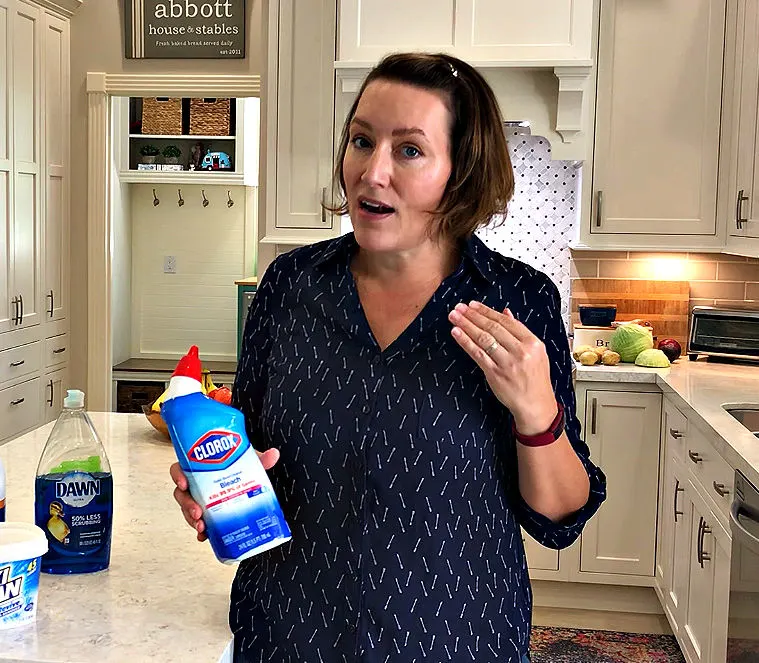 Image of someone holding toilet bowl cleaner, explaining how toilet bowl cleaner is bad for grout, can damage grout, and/or stain grout.