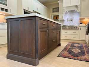 Image of a dark brown wood stain with a brown glaze on a kitchen island. Kitchen island design ideas.