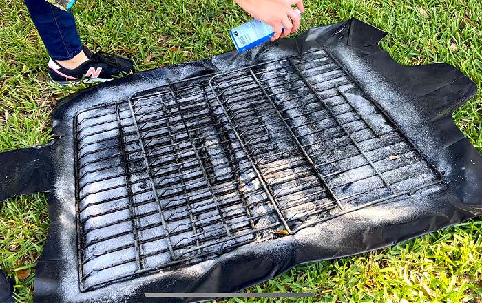 Cleaning oven racks with Easy Off Fume Free Oven Cleaner.